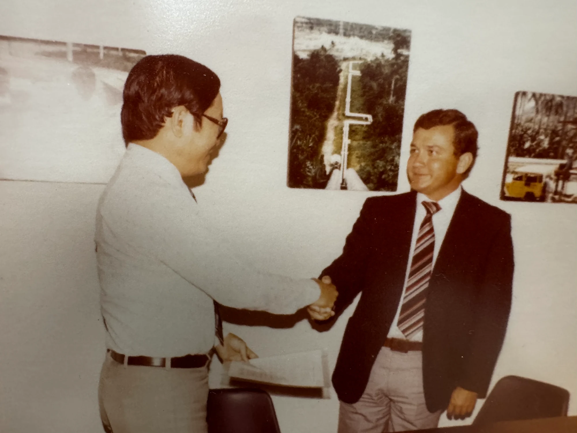 Two PPC representatives shaking hands during an early business meeting