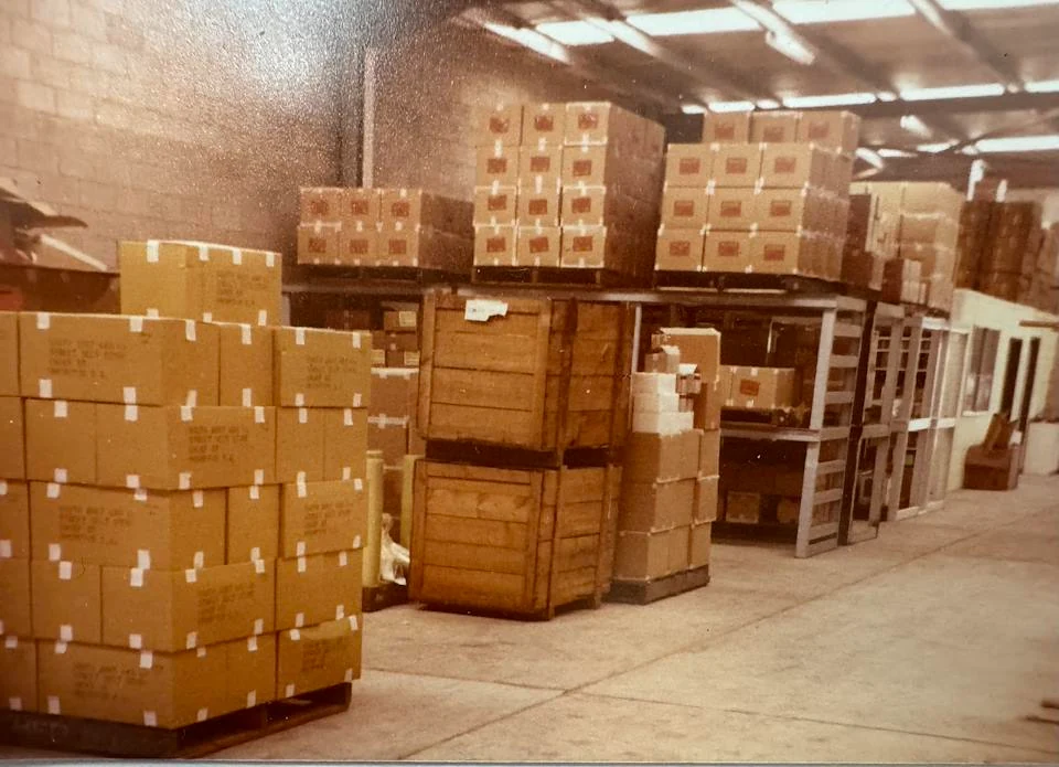 Stacks of packed cartons inside an early PPC warehouse